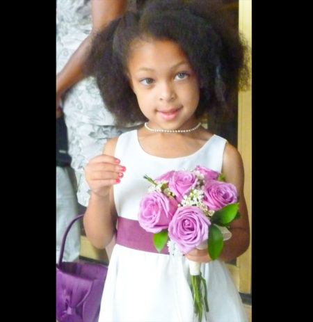 little girl in wedding with pink bouquet