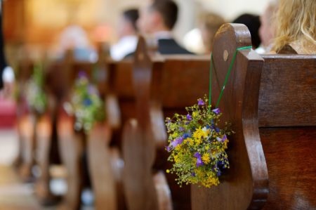 Flowers Hanging from Pews
