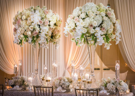 Traditional, romantic, and elegant wedding flower centerpieces at indoor reception