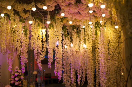 Stunning flowers hanging from ceiling at indoor wedding