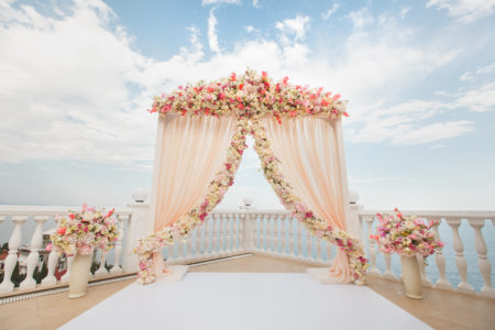 Beautiful pink and blush flower arch for outdoor wedding ceremony