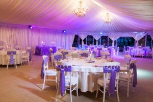 Tent wedding reception with purple lighting 