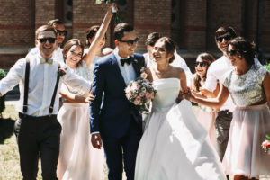 Wedding couple surrounded by happy bridal party
