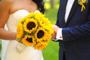Bride and groom with sunflower bouquet and sunflower boutonniere