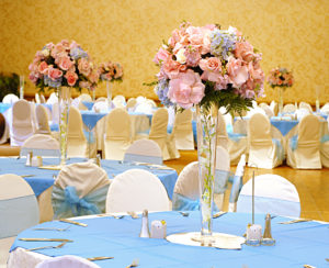 Elegant party with baby blue and light pink flowers and decorations for a gender reveal
